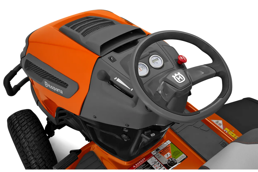 Orange and black lawn mower with steering wheel on a white background
