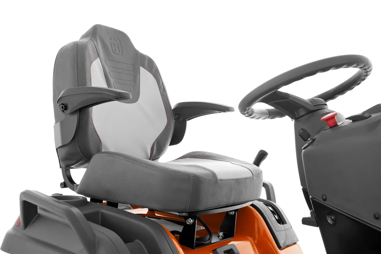 Gray seat and steering wheel of a piece of machinery on a white background