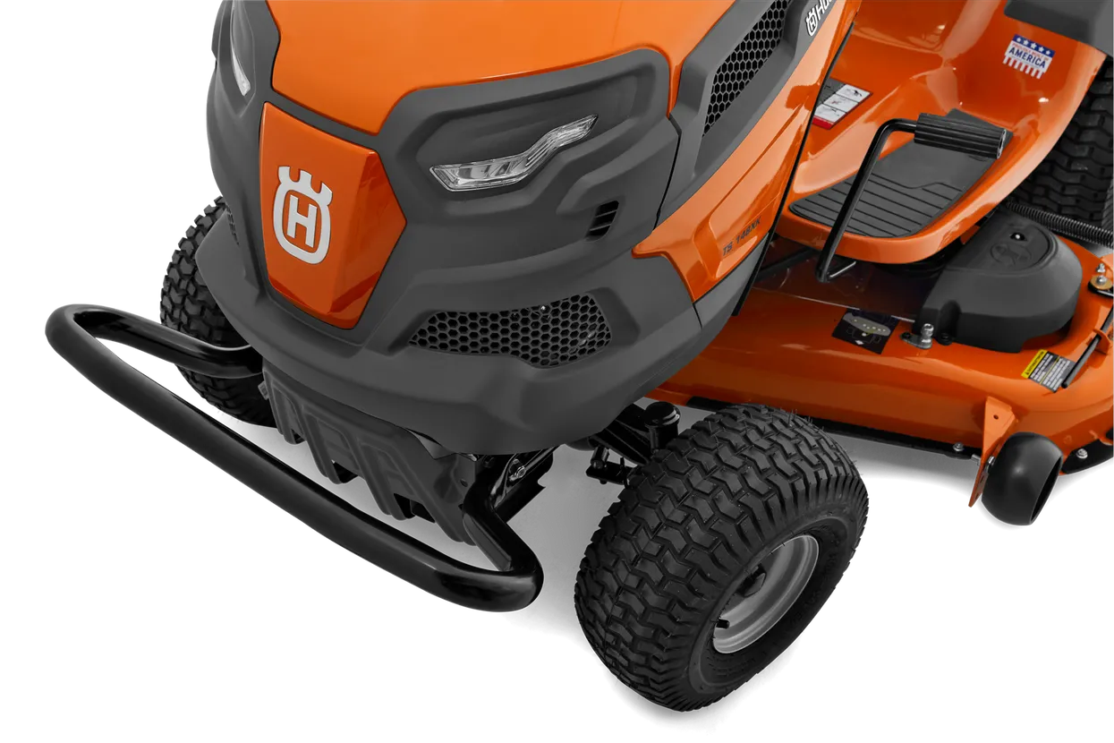 Close-up of an orange lawn mower with a visible Husqvarna logo on a white background